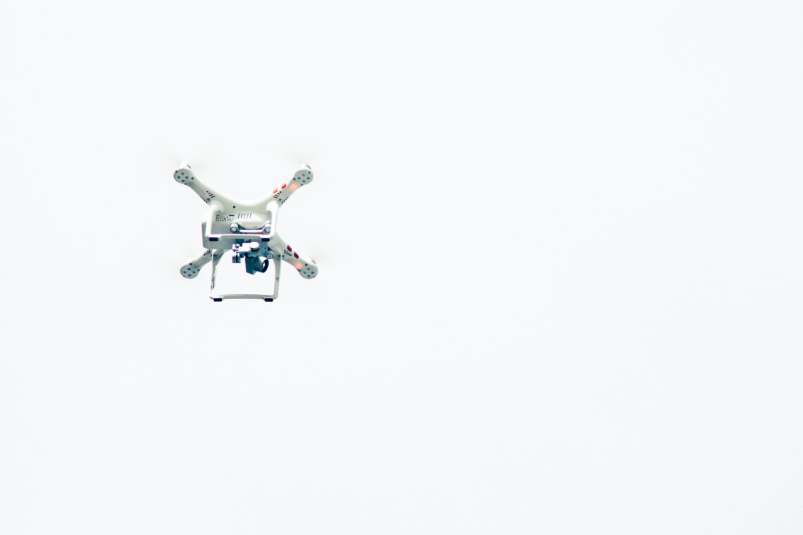 Drone flying in white sky